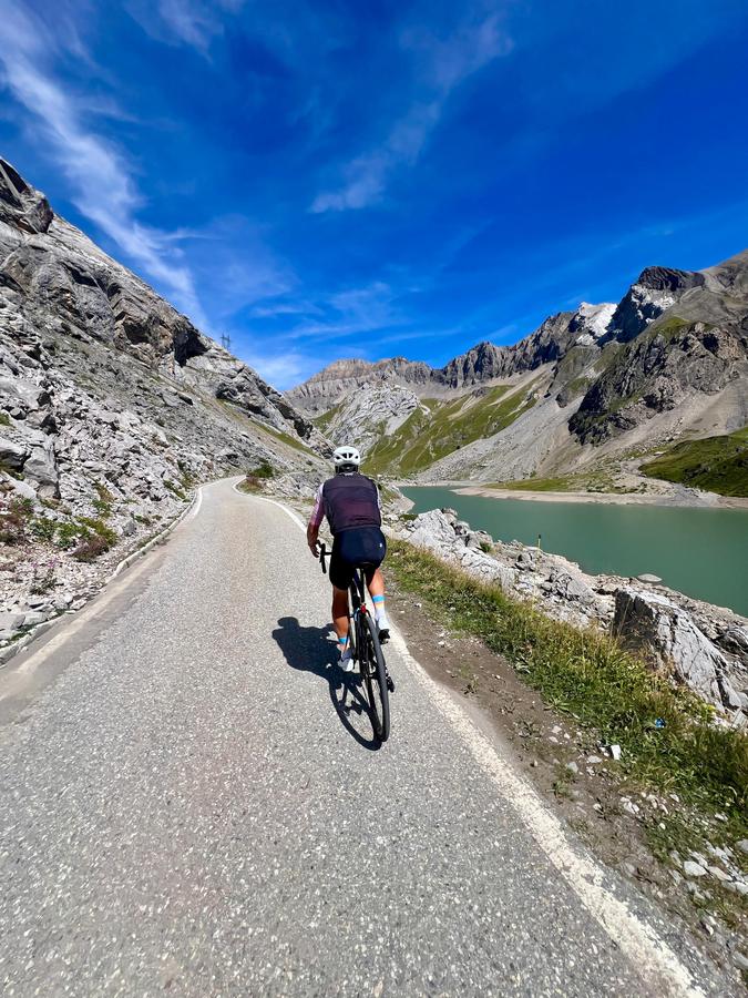 A rider on the road beside the Lac de Sénin reservoir