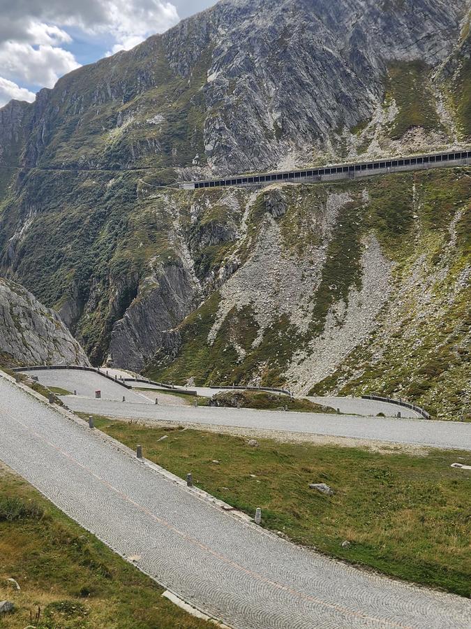 The Tremola bends curling down the valley below a rock wall