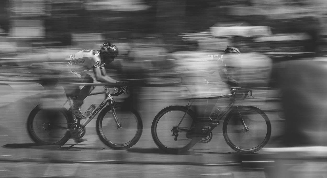 Two riders in a fast paceline, panned at speed